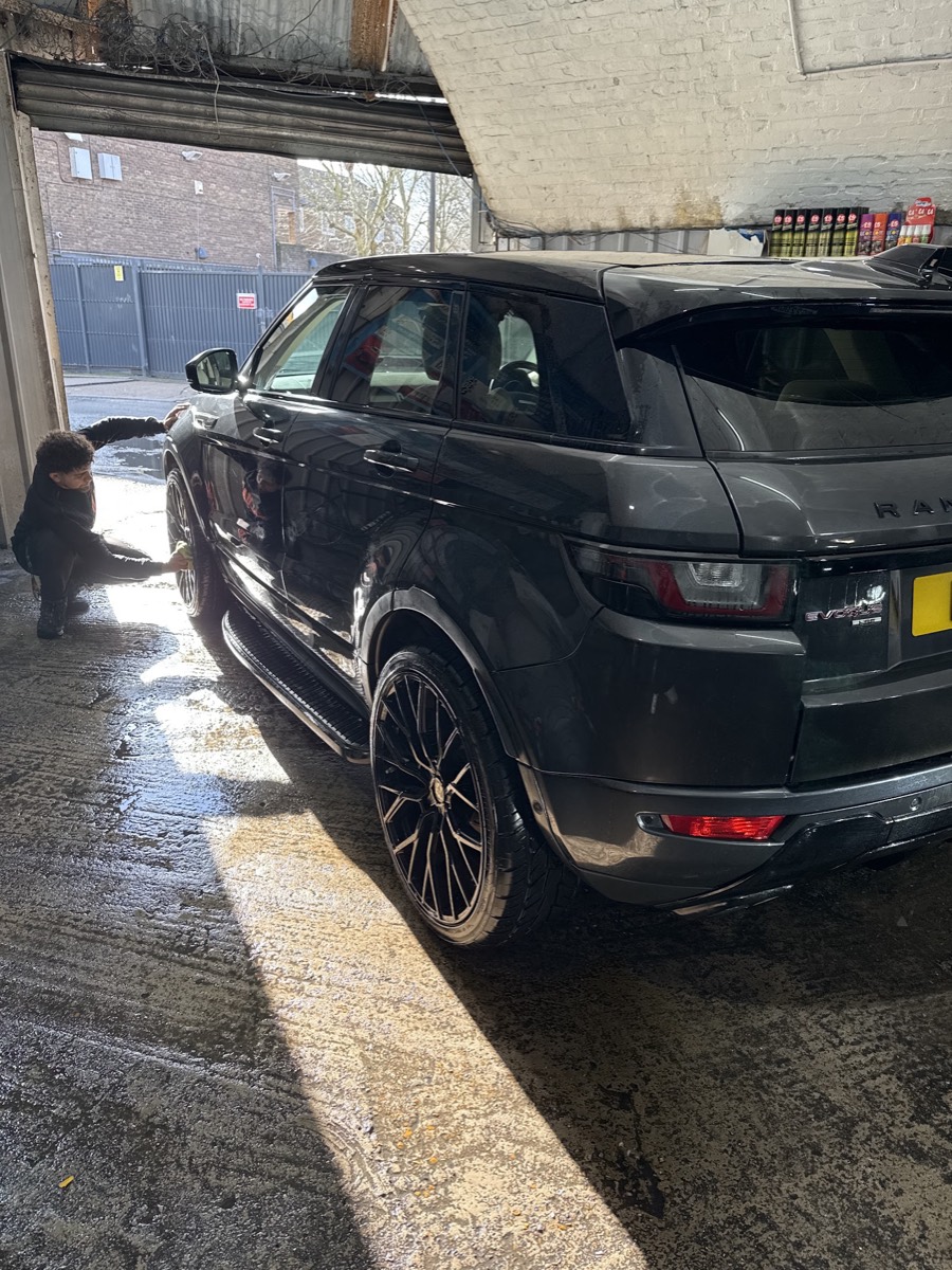 A Range Rover Evoque being hand washed by a Miami Car Wash valeter in the arch bay